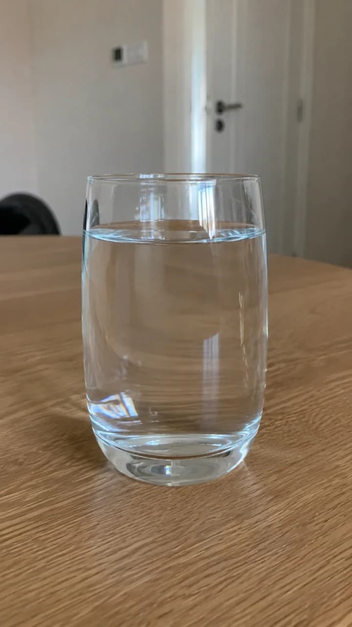 A glass of water seen through the camera on a live Ayah AI call